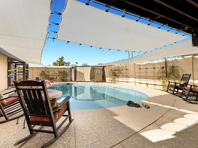 Large shaded backyard swimming pool.