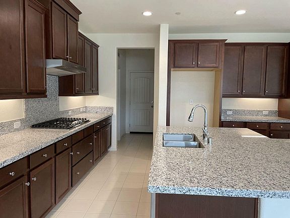 Kitchen, garage entrance. Laundry room is to the left and walk in pantry to the right of garage door.