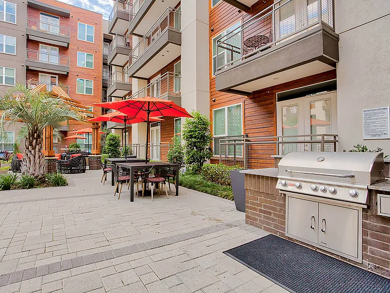 Outdoor grilling and lounge areas are located throughout the community.