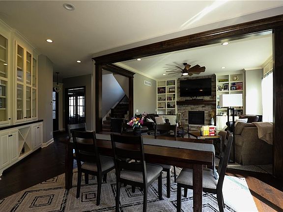 Dinner table leading into living room. Notice built in hutch.