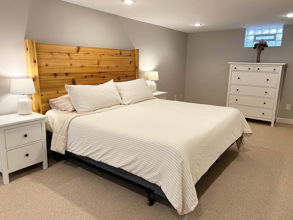 Spacious lower level bedroom featuring a king sized bed and a tempur-pedic mattress for the best night of sleep!