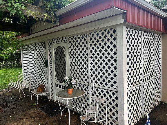 Exterior photo of screened in porch with view of Olympic size swimming pool