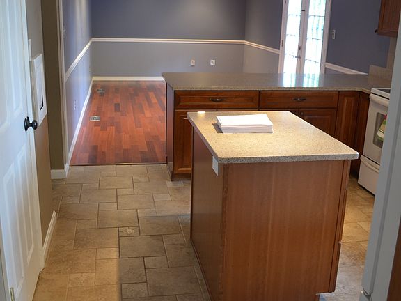 Kitchen with cherry cabinets and Silestone counters