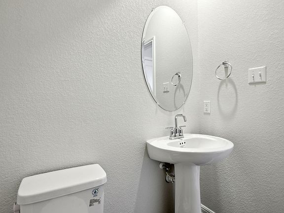 The first-floor powder bathroom is convenient for guests.