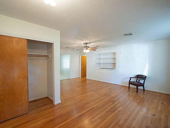 Front door entry to Living room with Coat closet.