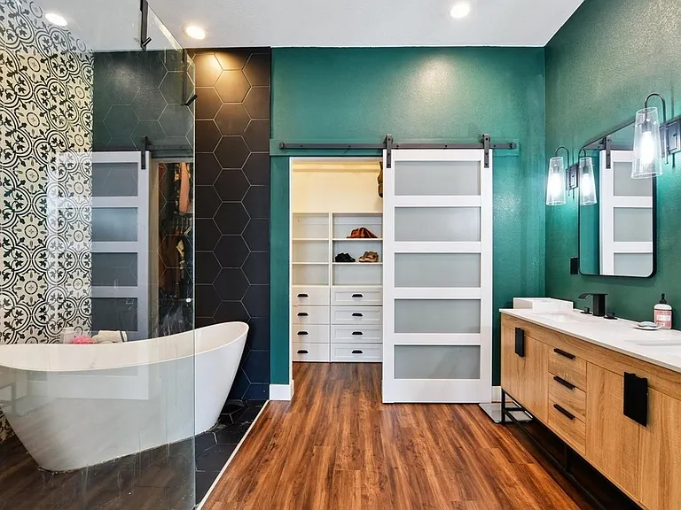 Master bathroom is designed for relaxation with huge soaker tube that is equipped to not go cold with the whole house tankless hot water heater and rainfall zero entry shower. Custom built closet with sliding door.