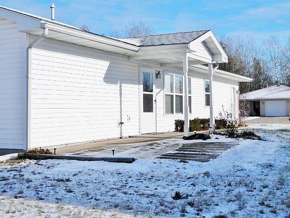 side of duplex with a patio