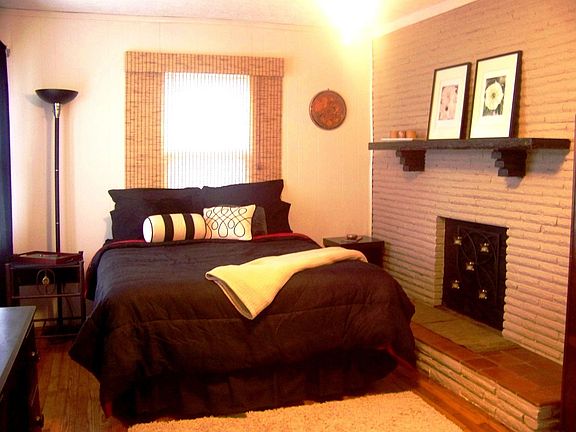 Master Bedroom with Stone and Brick fireplace