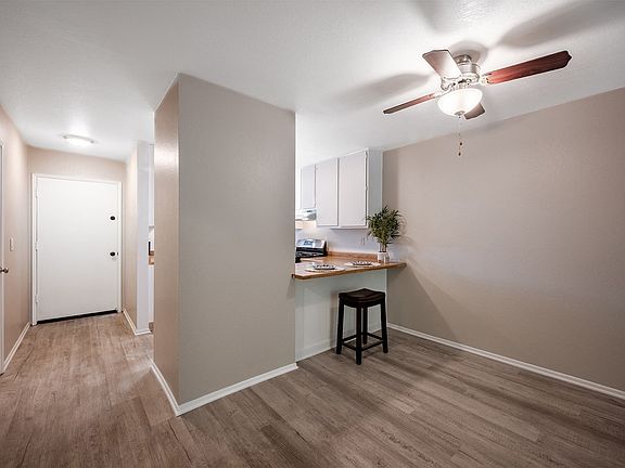 living room and kitchen with ceiling fan