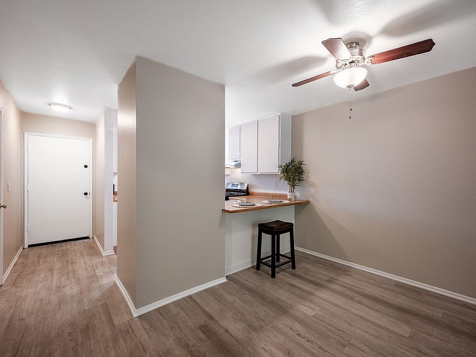 living room and kitchen with ceiling fan