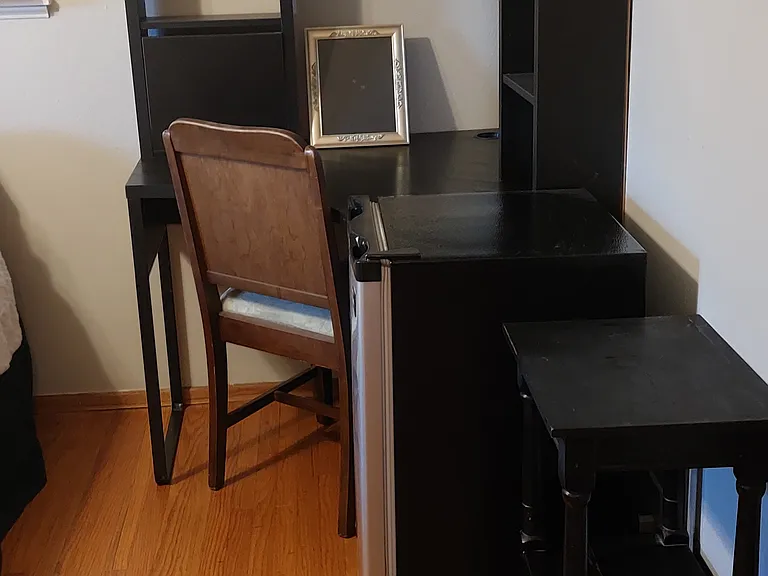 Corner desk, mini fridge, and additional storage