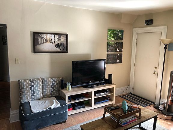 Living Area toward outside access door and Deck with Parking Access