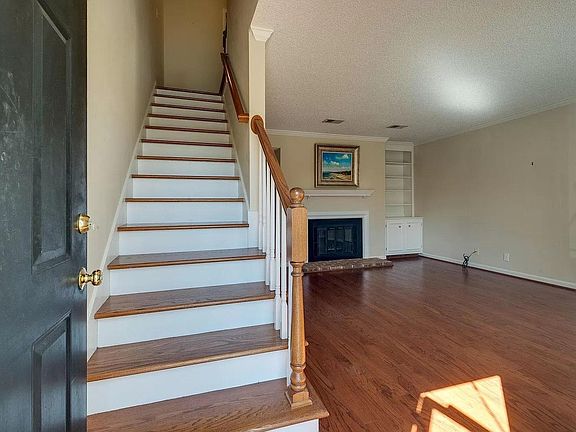 Another view of the stairs and living room from the entrance door.