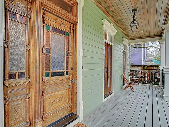The house integrates classic French Quarter architecture with contemporary design and touches of historical Americana, including an Eastlake front door inlaid with salvaged stained glass.