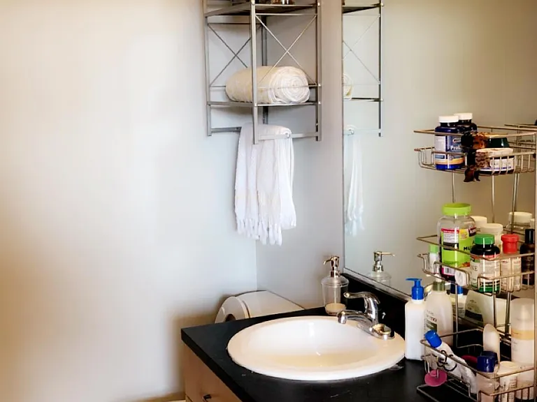 Bathroom attached to bedroom and also exits to main area.