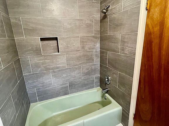 Bathroom new tile on the floor and the shower.