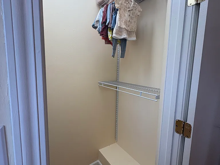 Second bedroom walk in closet with adjustable shelving system