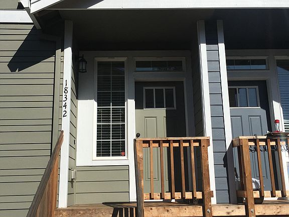 Front Door Entrance leads to spacious living room with cozy electric fireplace