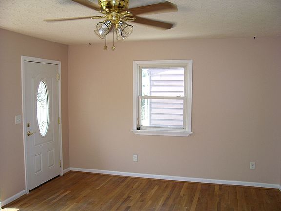 Living room is wired for surround sound & has a Hunter ceiling fan/light .