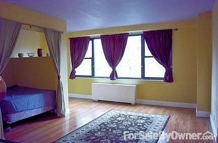 Unit 5L
						:
						Drapery up at alcove, bathroom to the right. Window 13 ft 8 in. wide.