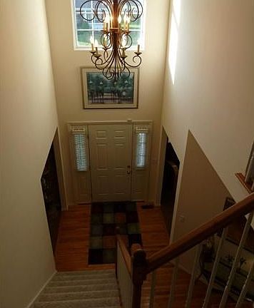 Two story entry foyer with split staircase.