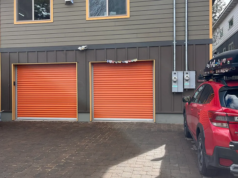Top two windows are from the dining room and living room of the unit. Entrance to the ADU/apartment is to the far right in front of the red car.