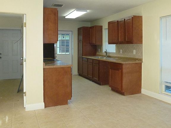 Galley kitchen with stainless steel appliances