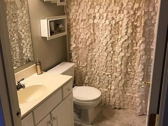 Main floor bathroom on hallway off kitchen