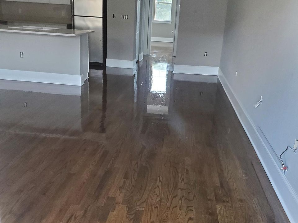 Entrance into the Condominium, with the kitchen visible and the entrance to the bedroom a the back of the unit.