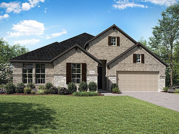 A two-story brick house with a gabled roof and a well-manicured lawn surrounded by lush greenery and