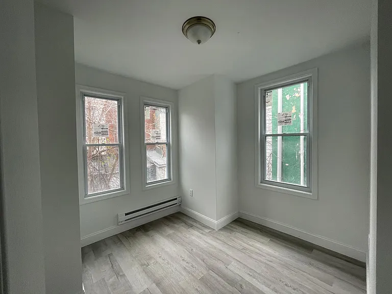 master bedroom with 3 windows and tons of light