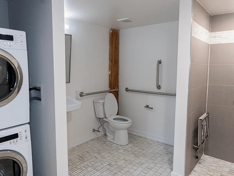 Experience ultimate convenience with a fully accessible bathroom and in-unit laundry setup.