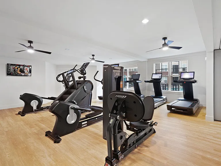 24/7 fitness center with designated cardio and strength areas