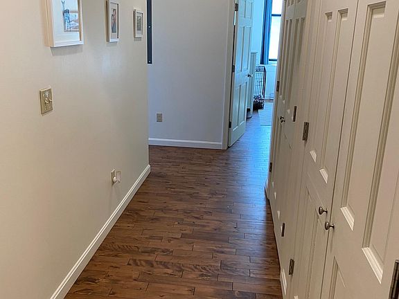 Hallway from entry to apartment. Large storage closet and laundry room on right.