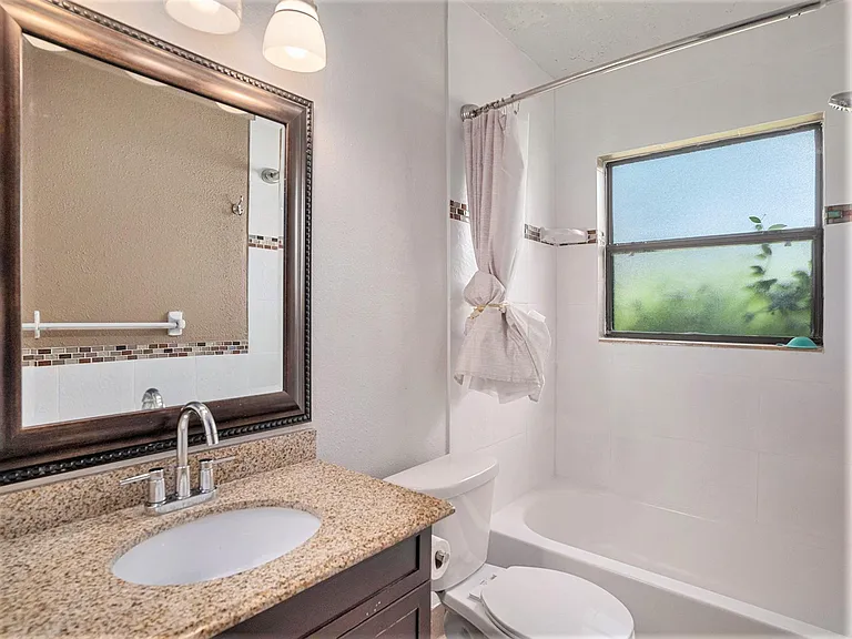 This bathroom is complete with a bathtub and standing shower.