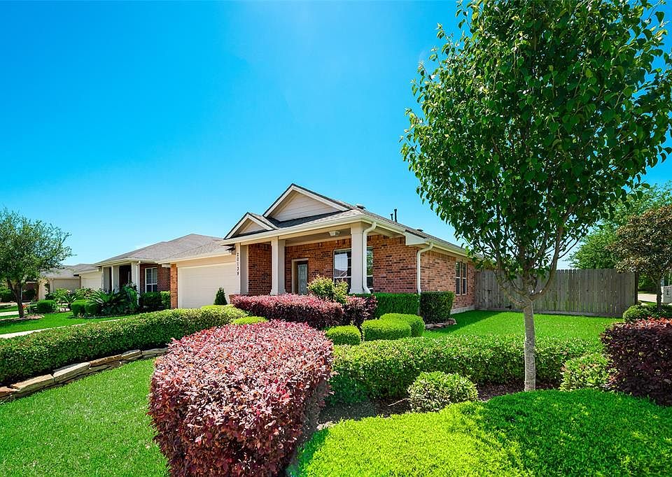 Welcome Home To This Beauty at 20139 Sunflower Chase! Notice the manicured landscape & large covered front porch!
