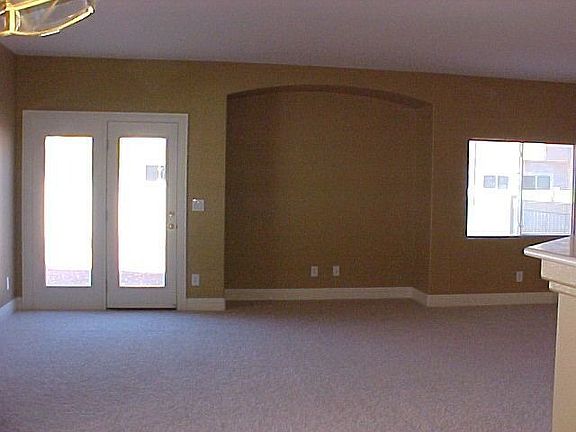 living room w/ media niche & french doors to backyard