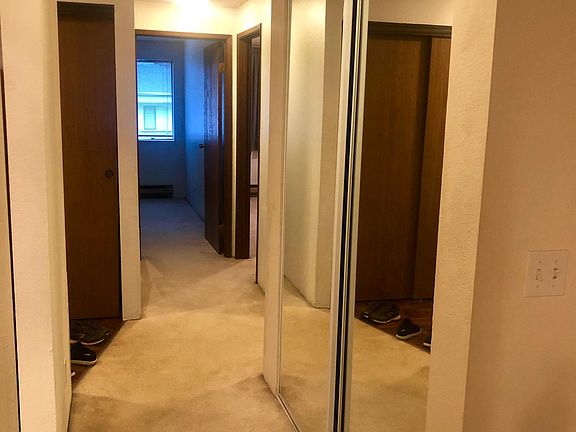 Hallway connecting bedrooms to living area and kitchen