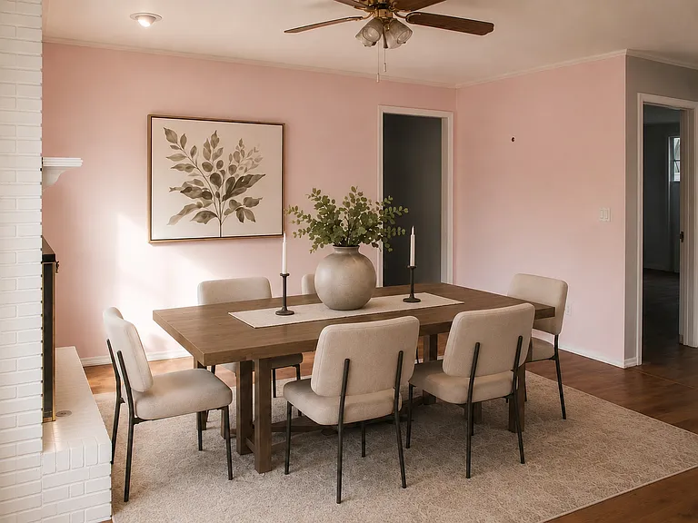 Large room off the kitchen with brick fireplace configured as a dining room.