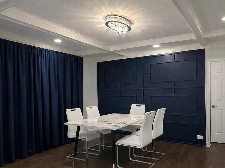 Dining room with table/chairs that can feed/seat four people.