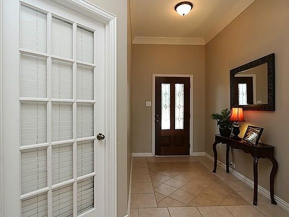 Tile entry to the home with study on the right.