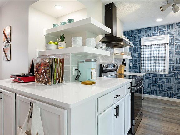 New quartz countertops, open shelving, new stainless steel appliances