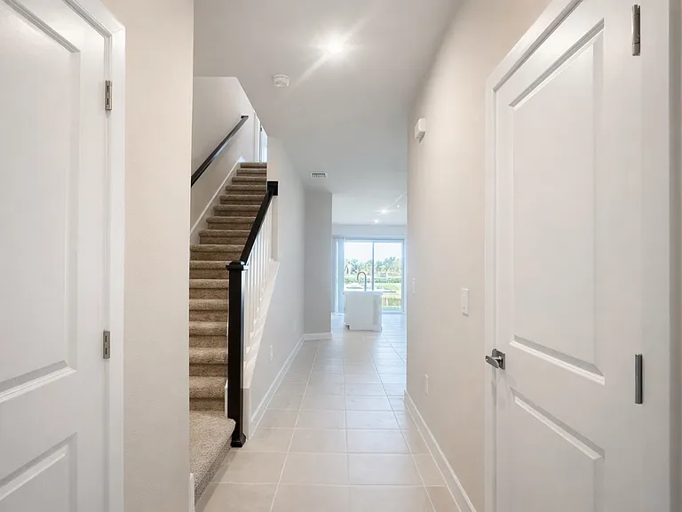 entry, left is half bath, right side is the garage