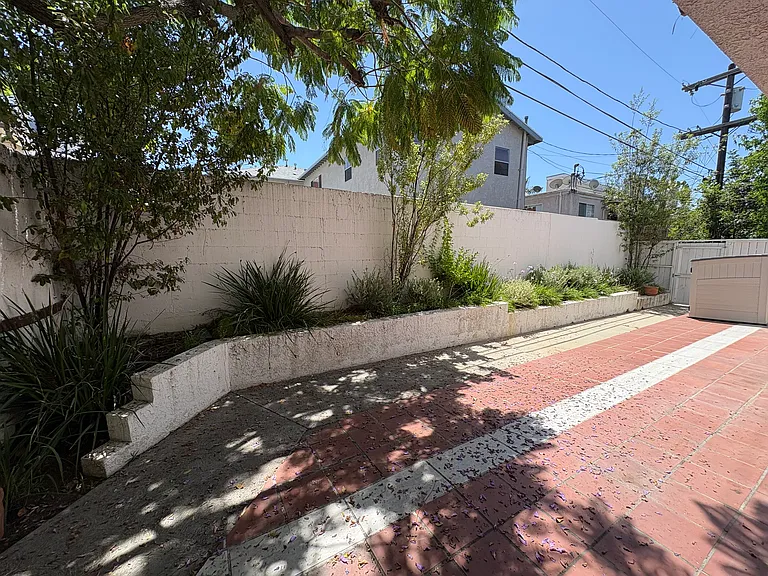 Large private patio with storage shed