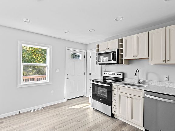 Kitchen leads to back deck and large yard