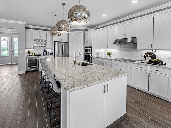 Model Representation Gourmet kitchen with stainless steel gas appliances, white 42 maple cabinets
