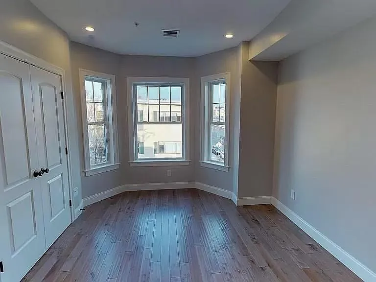 Primary bedroom with great light + custom built in closet