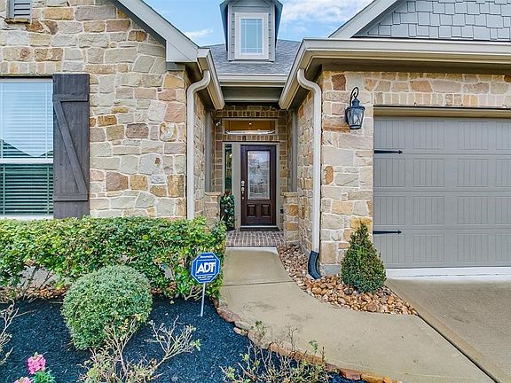 Your guests will receive a warm welcome with Allen&Roth custom lights and lush landscaping. Notice the extended gutters to keep your front porch dry and security camera for extra privacy and peace of mind.