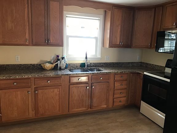 Wood cabinets and Luxury Vinyl Flooring create a comfortanble Kitchen