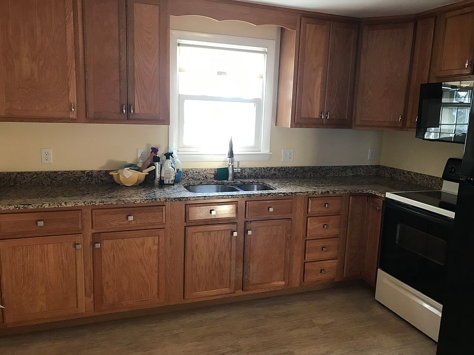 Wood cabinets and Luxury Vinyl Flooring create a comfortanble Kitchen